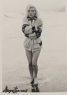 George Barris, a black and white photograph of Marilyn Monroe on a beach, signed in black ink by Barris to the lower edge of the image, stamped to the reverse; ‘ 1987 George Barris/Marilyn Monroe Weston Editions Ltd. All
